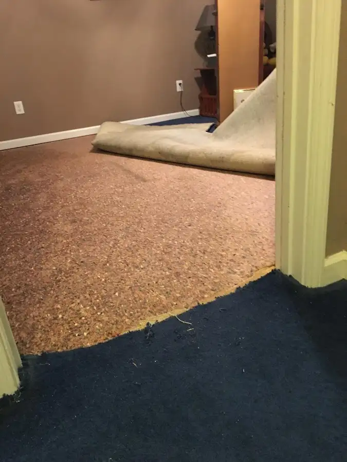 Carpet pad removal revealing water damage during Drying & Dehumidification in Grand Prairie